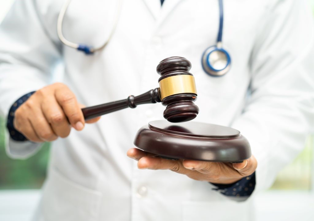 A doctor holds a judge's gavel